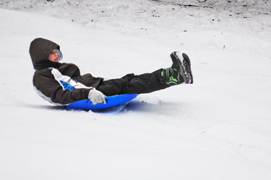 sliding on a snow saucer