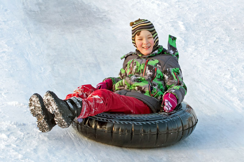 child riding in a snow tube